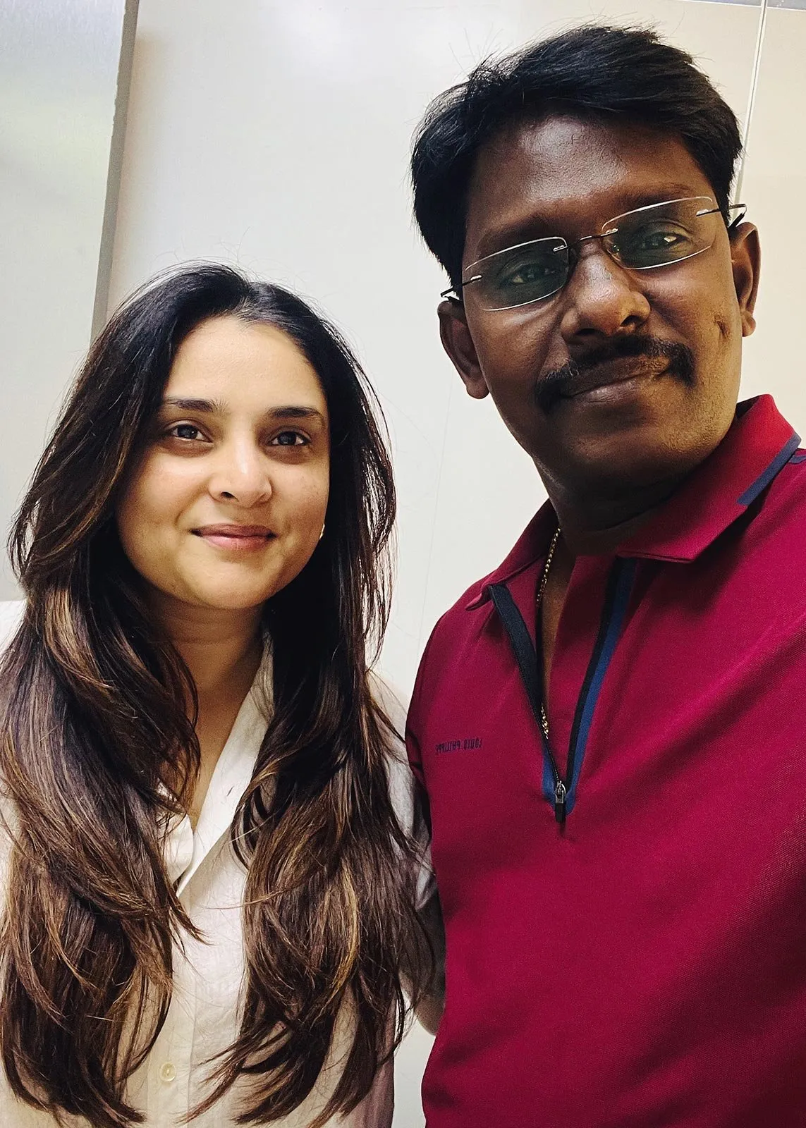 A woman and a man standing side by side indoors at the clinic.